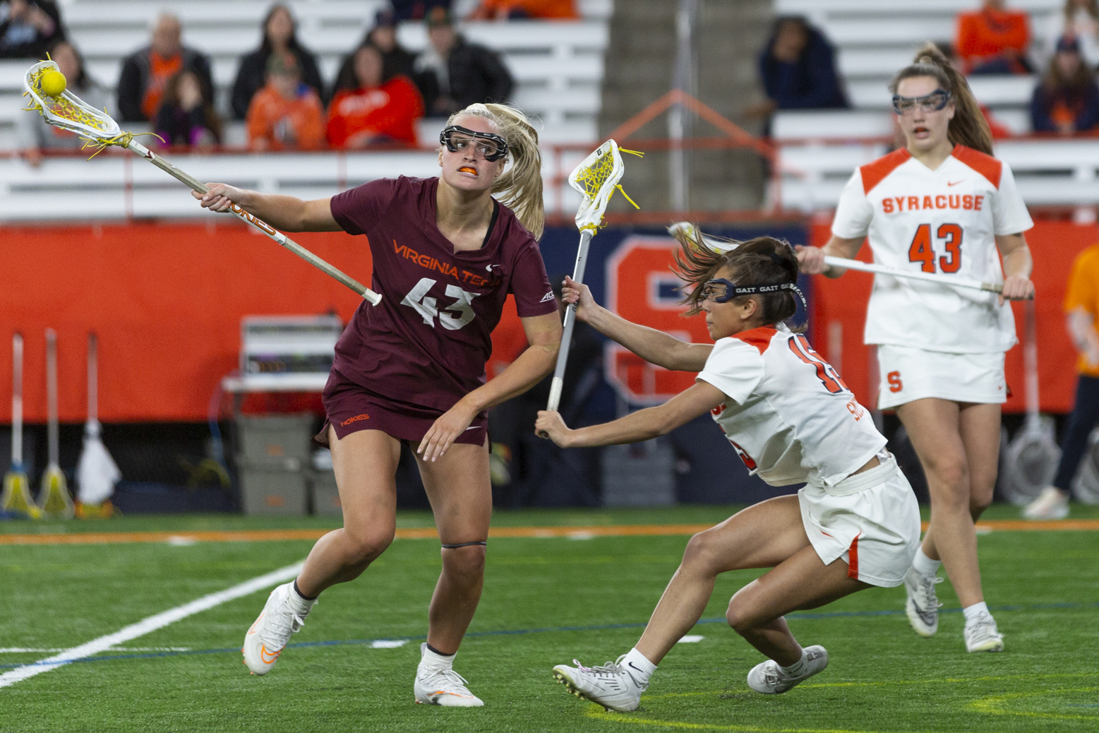 SU player, Natalie Smith, defends against number 43 as she attempts to score.