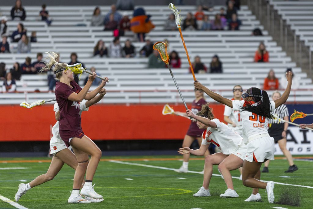 The Syracuse Women's lacrosse defense crashes as VTech drives to goal.