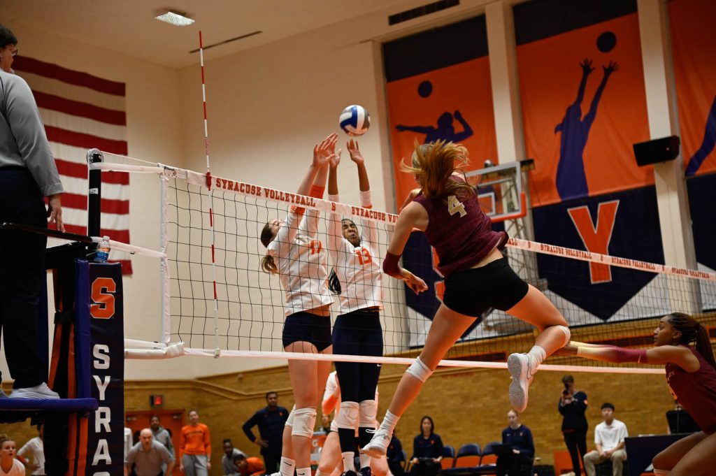SU's Lauren McCabe (#17) and Zharia Harris-Waddy (#13) go up to block a hit from FSU player Audrey Koenig (#4).