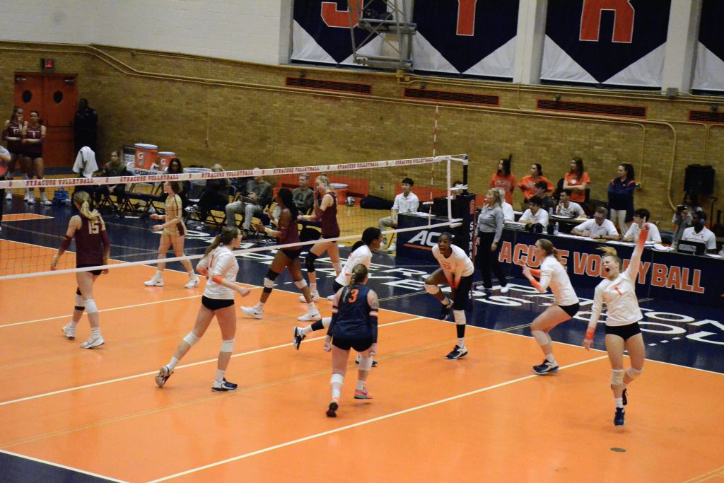 Syracuse volleyball players celebrate after a point during the match against Florida State at the SU Women's Building on Friday, Nov. 10, 2023.