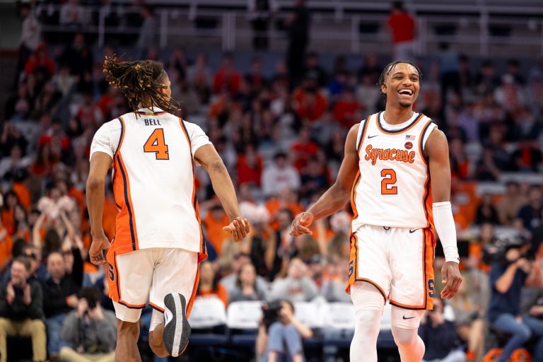 Syracuse's Chris Bell (#4) and J.J Starling (#2) celebrate down court after scoring against the Louisville Cardinals on Wednesday night.