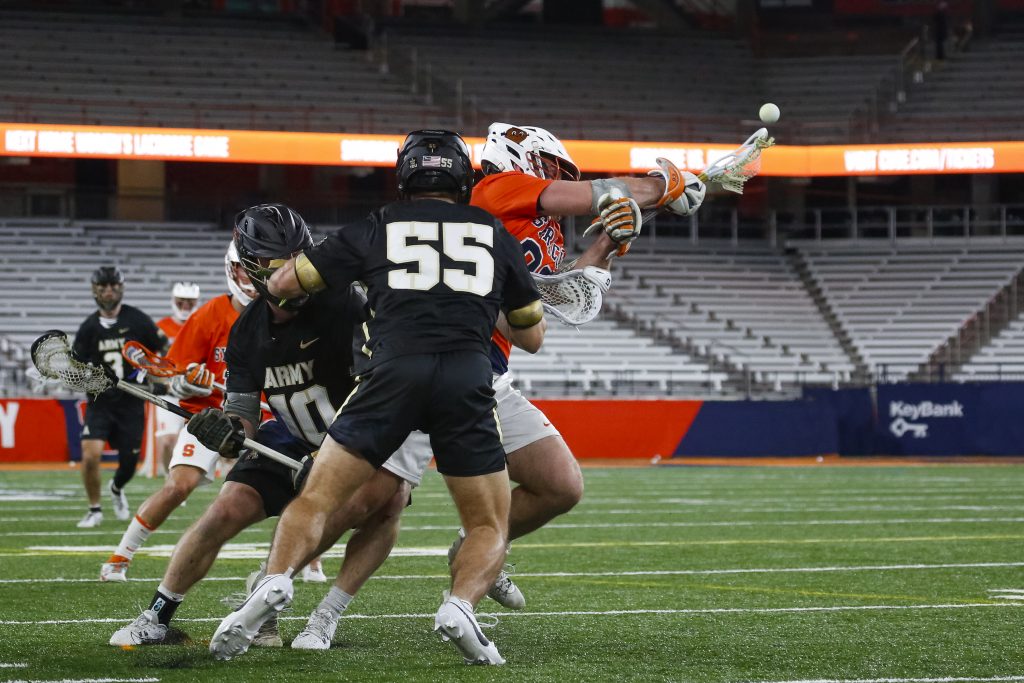 Syracuse's Mason Kohn (#93) gains possession of the ball between the Army players on Wednesday night.
