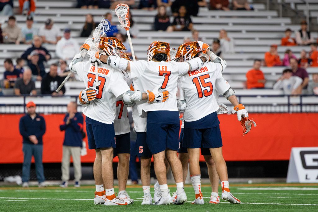 The Orange huddle in before the face-off with Manhattan onFriday in the Dome.