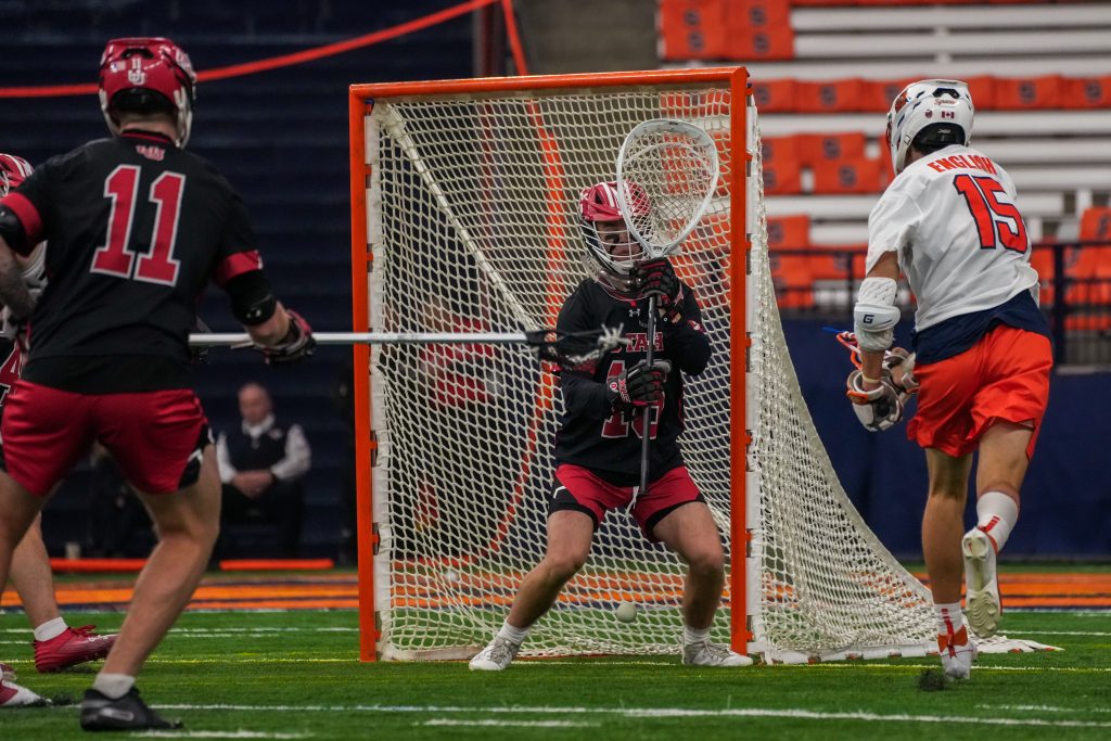 Midfielder Sam English (#15) threads the needle for an SU goal against Utah on Wednesday afternoon in the JMA Wireless Dome.
