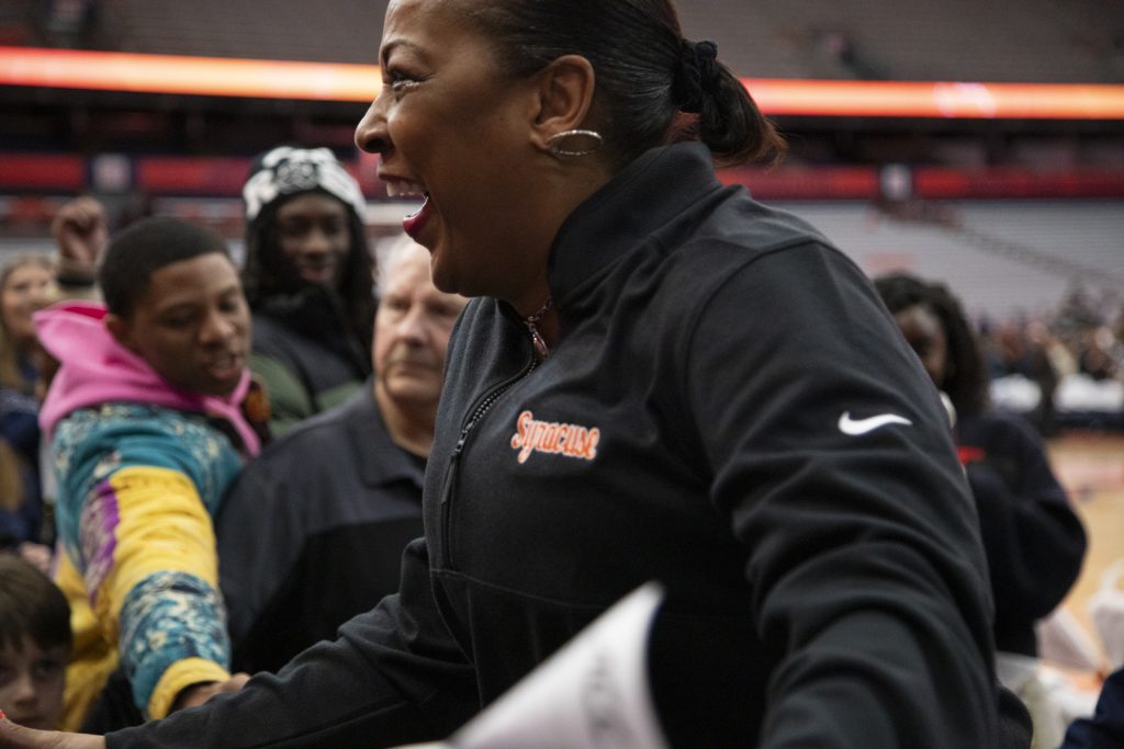 Orange woman's basketball Coach Felisha Legette-Jack celebrates with fans after the game on Sunday, February 11.