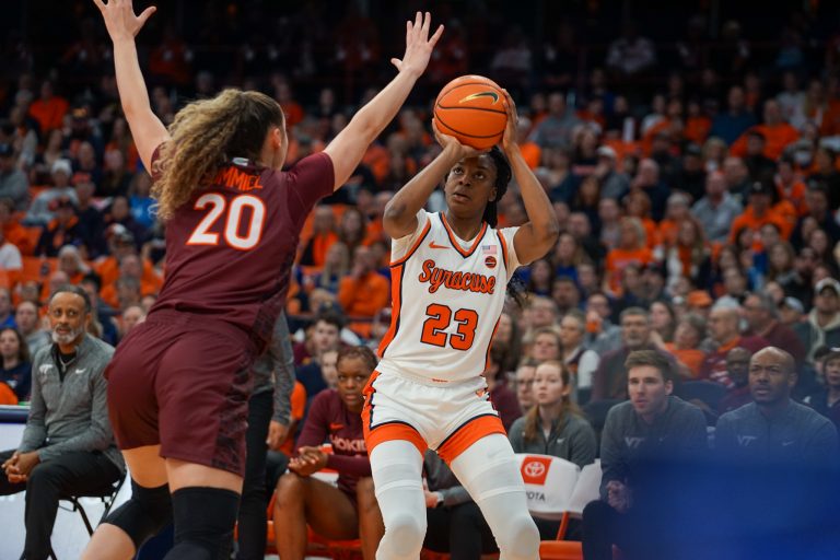 SU's Alyssa Latham (#23) takes a three as Virginia Tech Olivia Summiel (#20) goes for the block against Virginia Tech on Jan. 28, 2024, in the JMA Wireless Dome.
