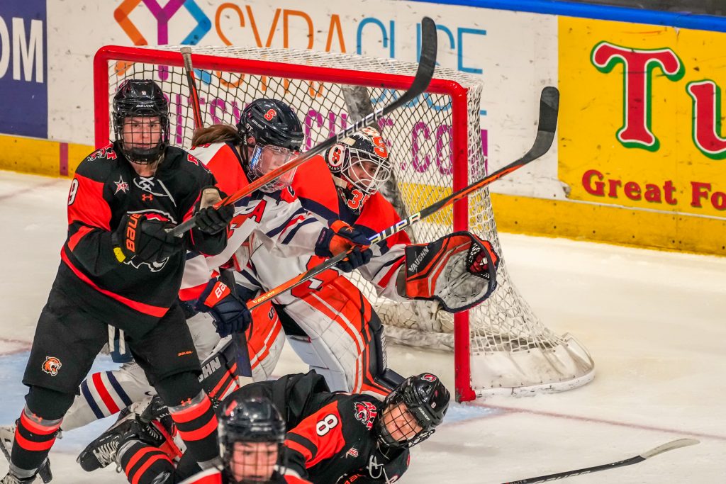 SU goalie Allie Kelley (#35) reaches to save the puck after an RIT shot-on-goal at Saturday's game.