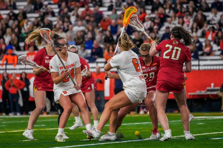 Attacker Payton Rowley (#6) and midfielder Emma Tyrrell (#24) fight Maryland defense for possession on Saturday in the JMA Wireless Dome.