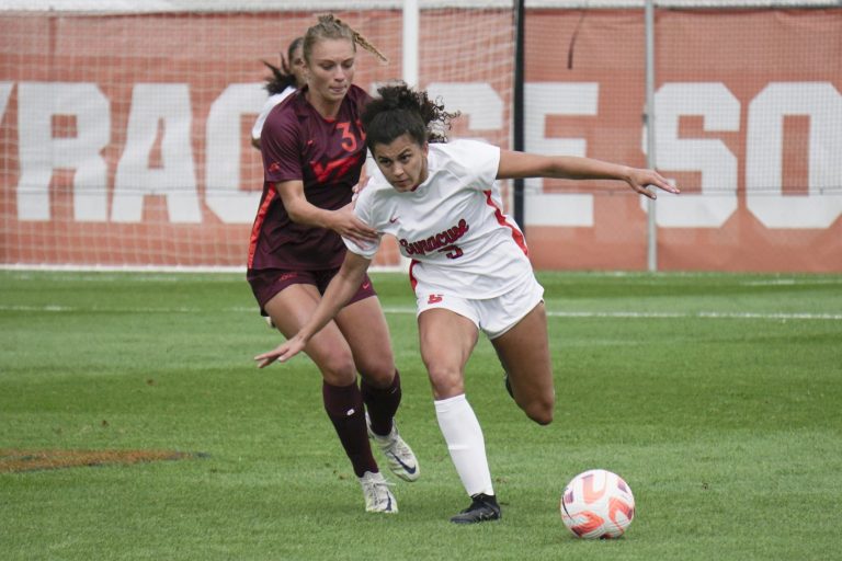 Two players battle for the ball during the Syracuse-Virginia Tech women's soccer game at SU Soccer Stadium on Sept. 24, 2023.