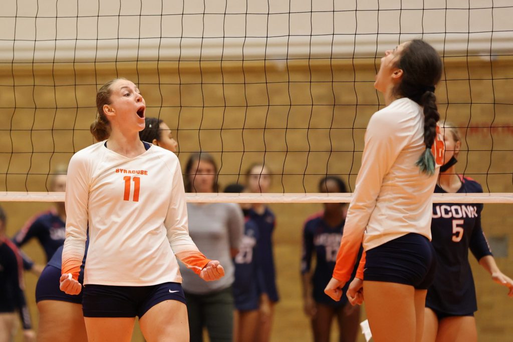 Syracuse's Polina Shemanova (left) reacts with Abby Casiano (right) after a kill against University of Connecticut at the Women's Building on August 27, 2021