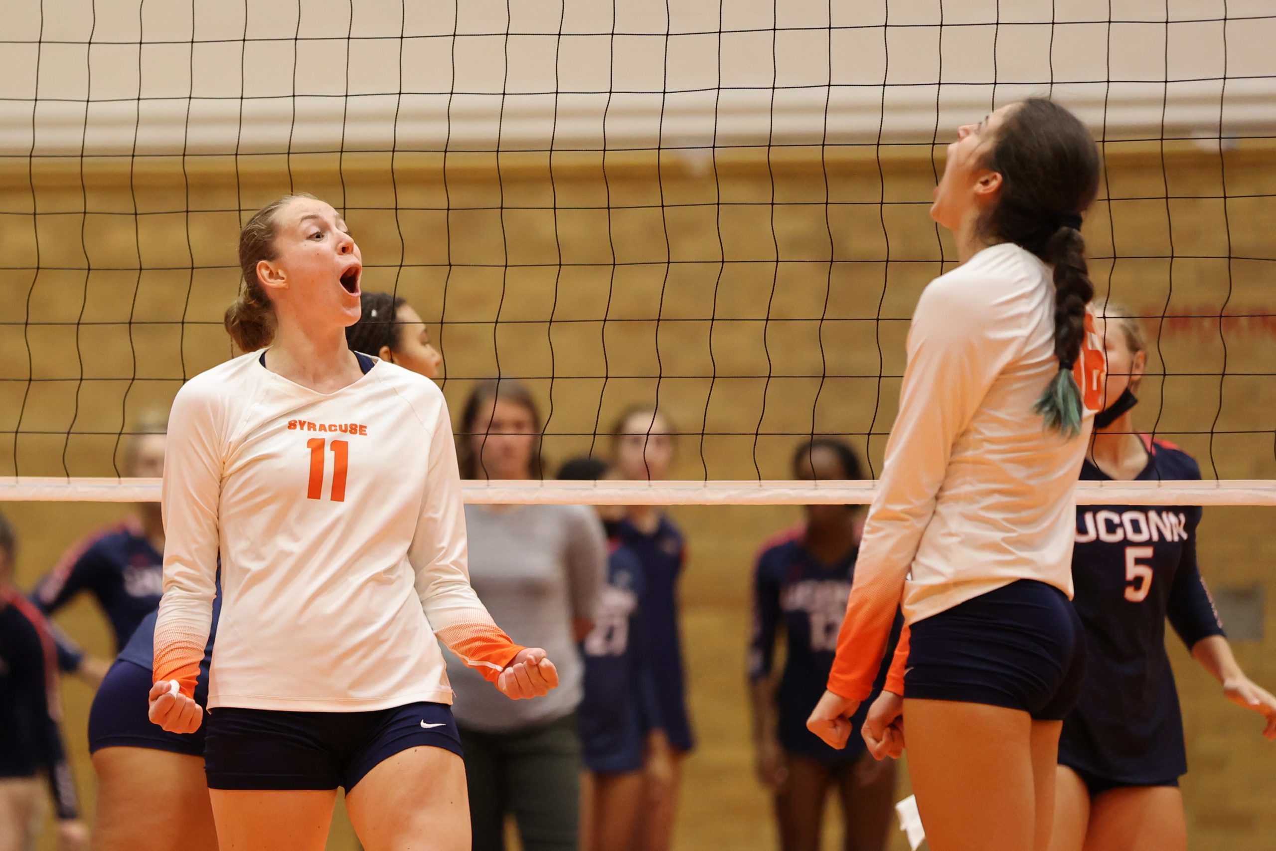 Syracuse's Polina Shemanova (left) reacts with Abby Casiano (right) after a kill against University of Connecticut at the Women's Building on August 27, 2021