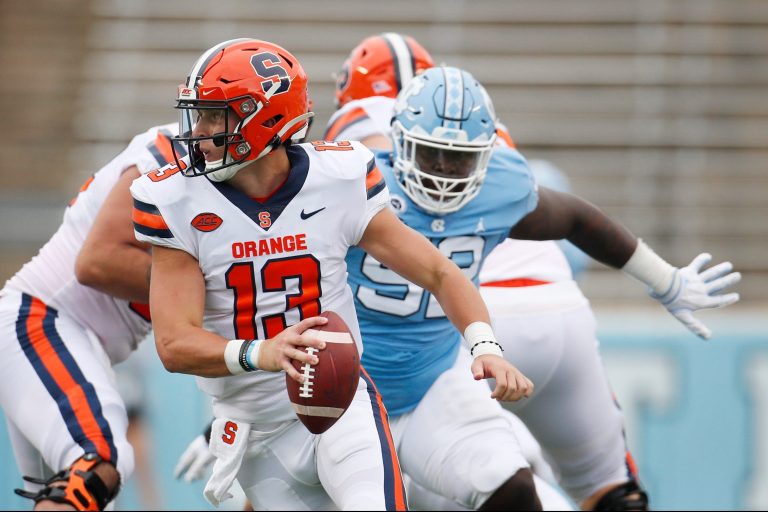 Syracuse quarterback Tommy DeVito (13) scrambles to avoid UNC defender Jahlil Taylor (52) in first half action against North Carolina at Kenan Stadium on Saturday, September 12, 2020 in Chapel Hill, N.C.