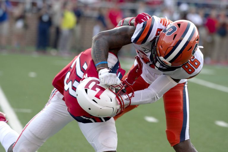 Syracuse wide receiver Trishton Jackson gets entangled with Liberty defender Kei'Trel Clark.