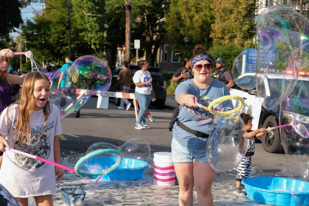 Visitors of the Wescott Cultural Fair enjoy the bubble station on Sunday.
