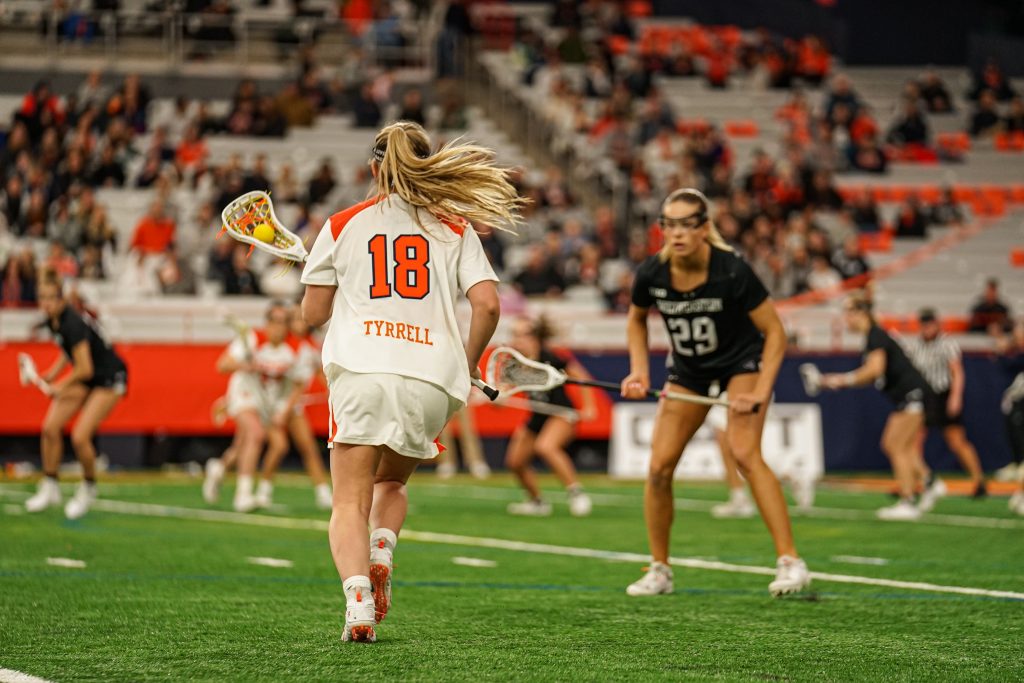 Meaghan Tyrrell (#18) scores 2 goals for the Orange in their first game of the season, beating NU 16-15 in a close game until the end.