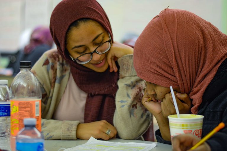 SU student Dina Eldawy tutors in the high school girls room at the Northside Learning Center.