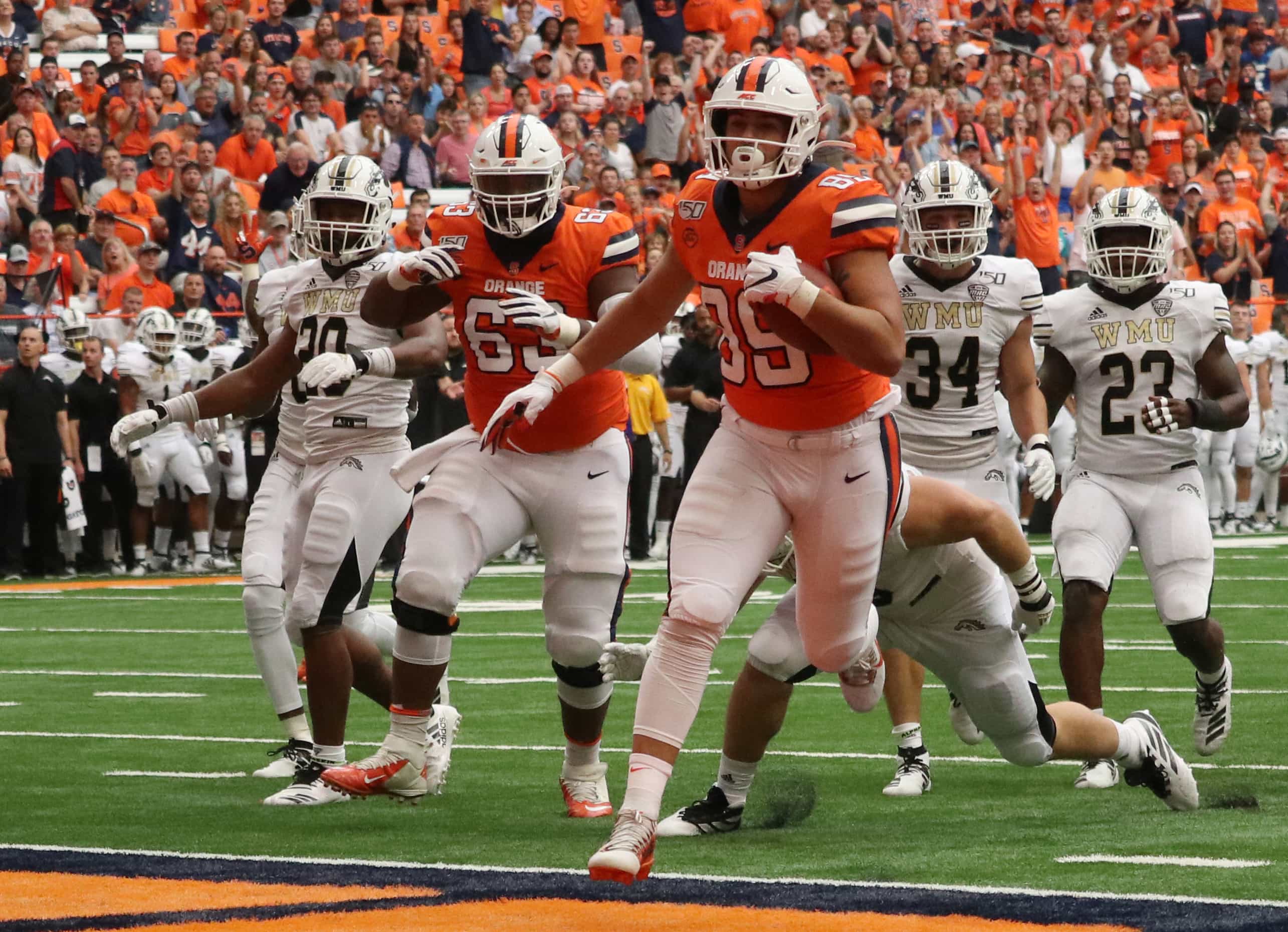 Syracuse University’s tight end Aaron Hackett (89), pushes through Western Michigan University’s defense for a touchdown. Syracuse University beat Western Michigan University with a score of 52-33.