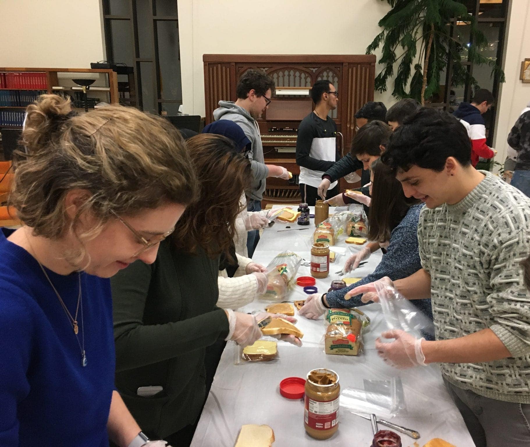 Students and faculty from different religious associations on campus came together to make PB&J and turkey sandwiches to donate to the poor at the Samaritan Center and Assumption Church Food Pantry