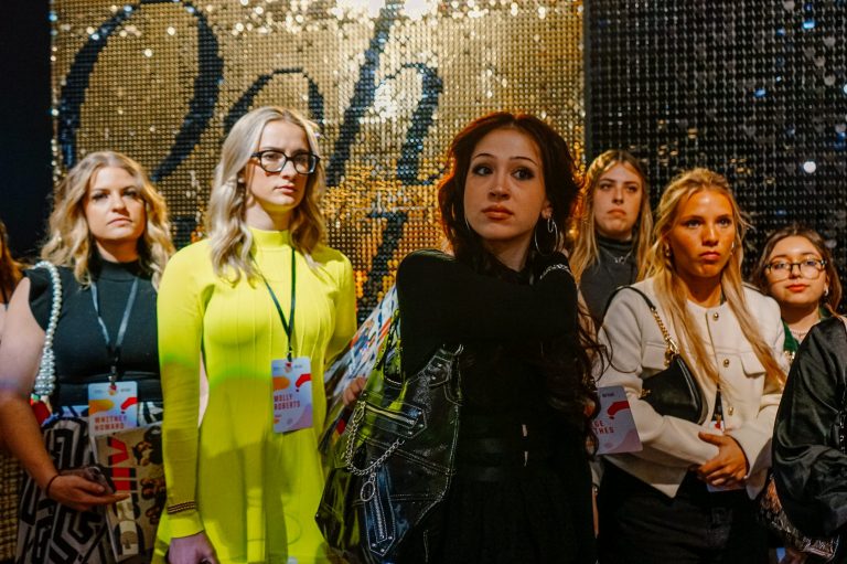 Paige Mathis and others standing in front of a wall at New York Fashion Week