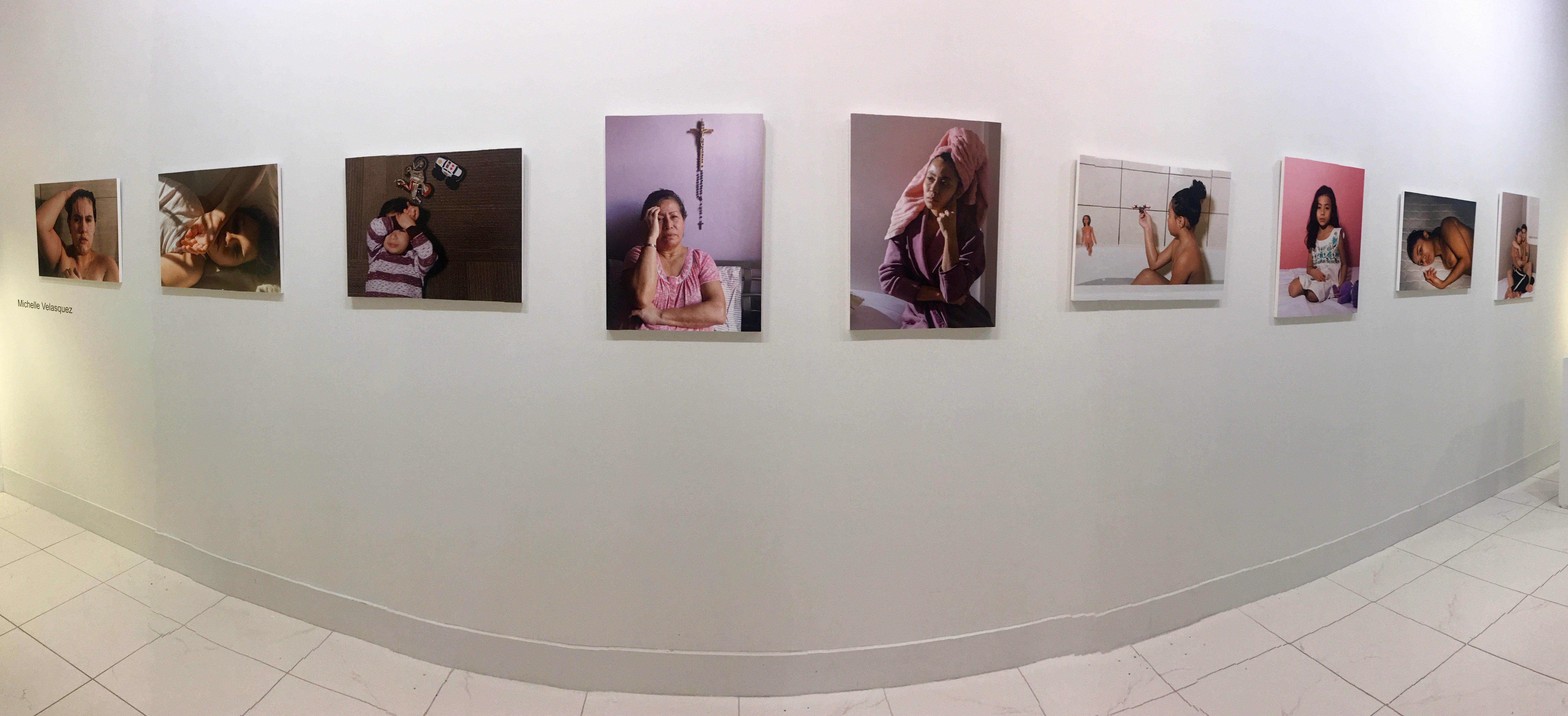 Gallery display of Michelle Velasquez's 'Mi Vida/My Life' photo exhibition.
