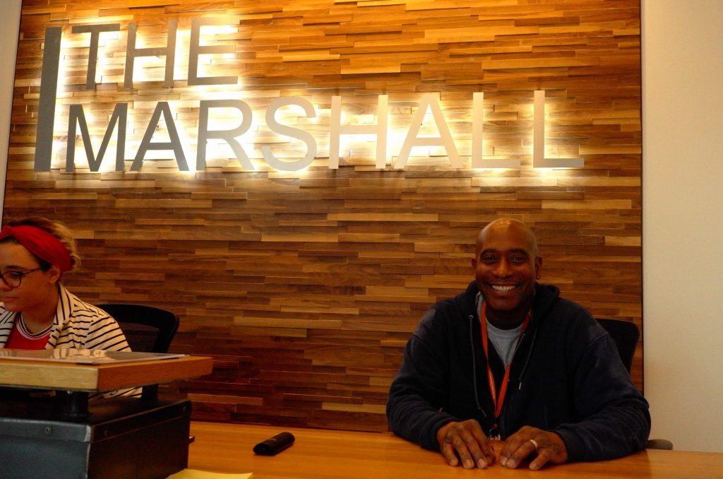 Ken Culley stands at The Marshall desk.