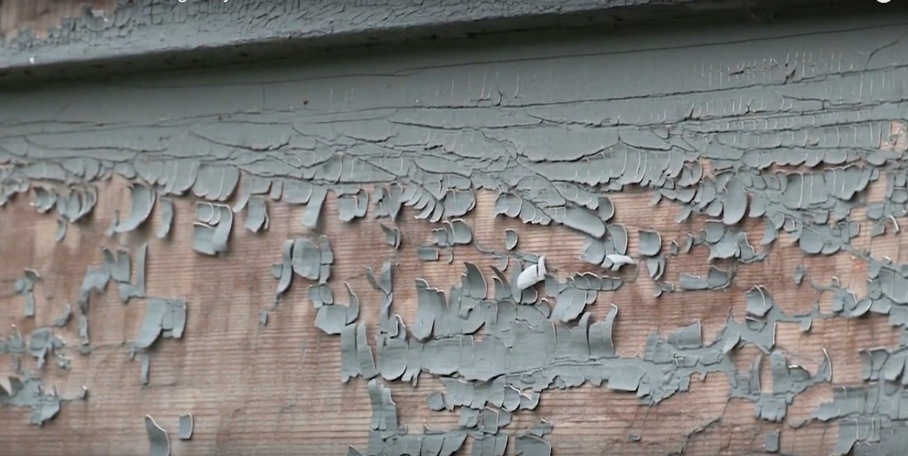 Lead paint peeling off a Syracuse house, posing a potential risk of lead poisoning