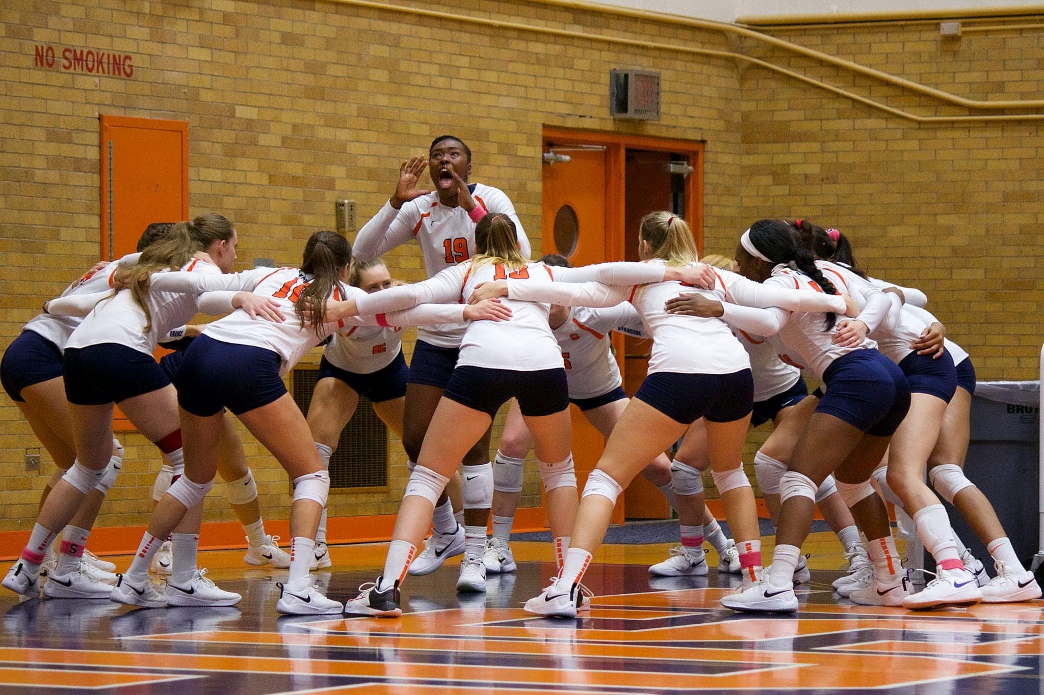 Middle blocker Santita Ebangwese leads the SU volleyball squad in a pre-game chant.