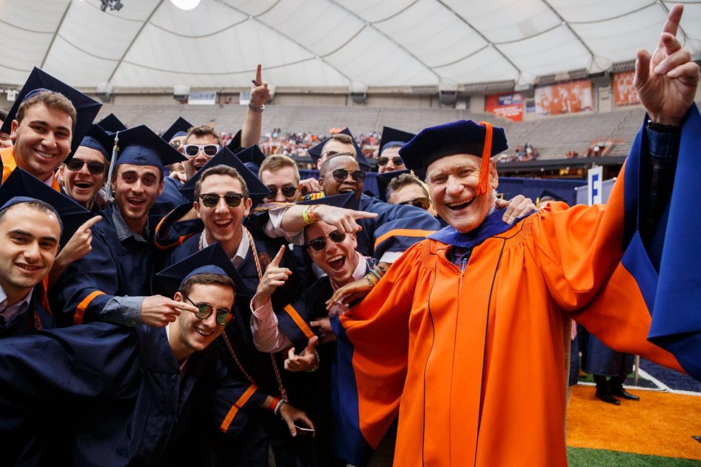 Marvin Druger, Professor Emeritus, Biology and Science Education, joins students from the College of Arts and Sciences for a photograph before they proceed to their seats.