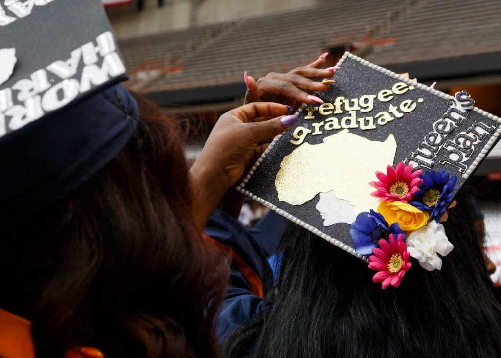 Graduating is all part of "queen's plan" for one student as she gets help to ensure everything sticks to her graduation cap.