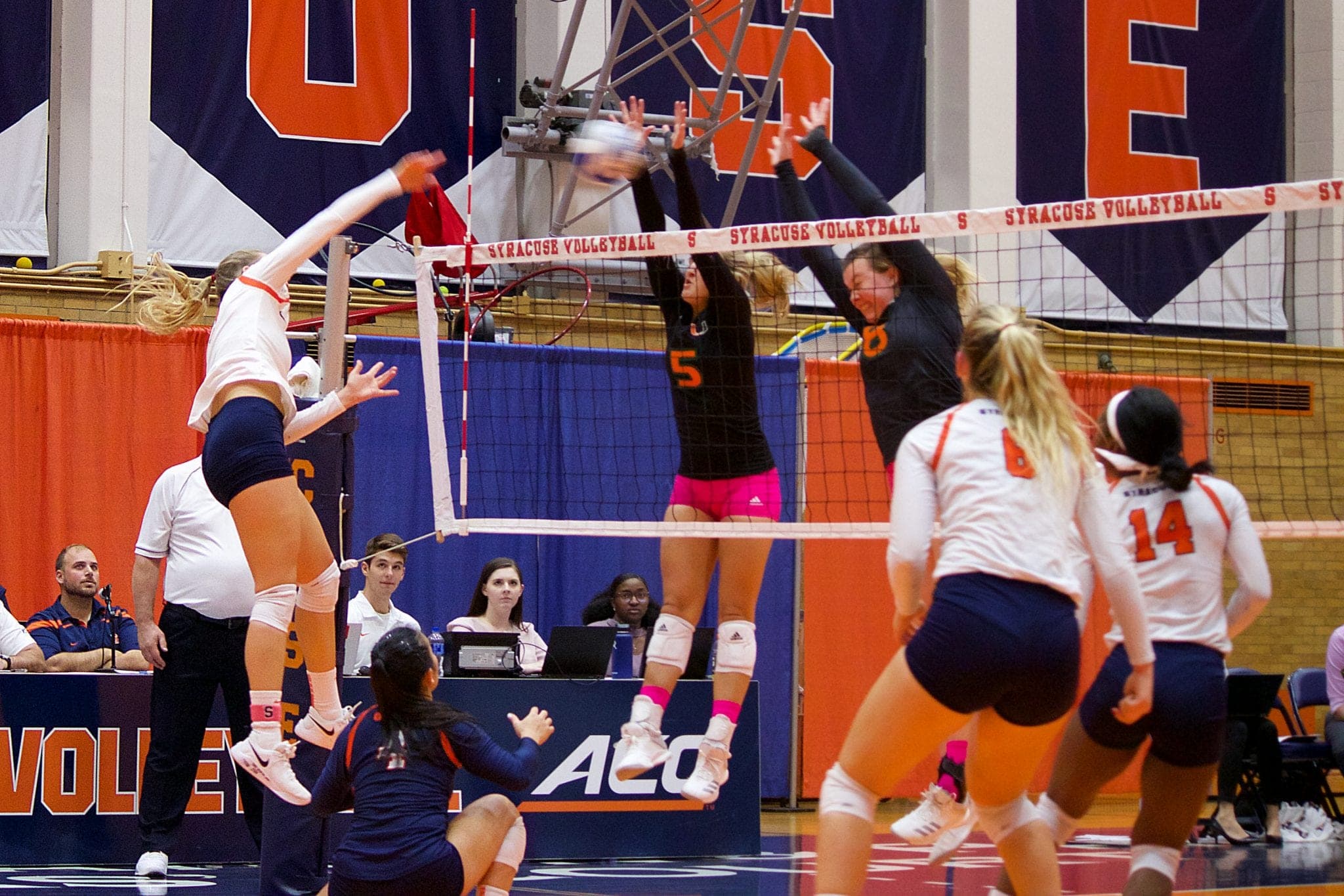 Syracuse spikes the ball on Miami defenders Friday during the Orange's 3-1 conference win.