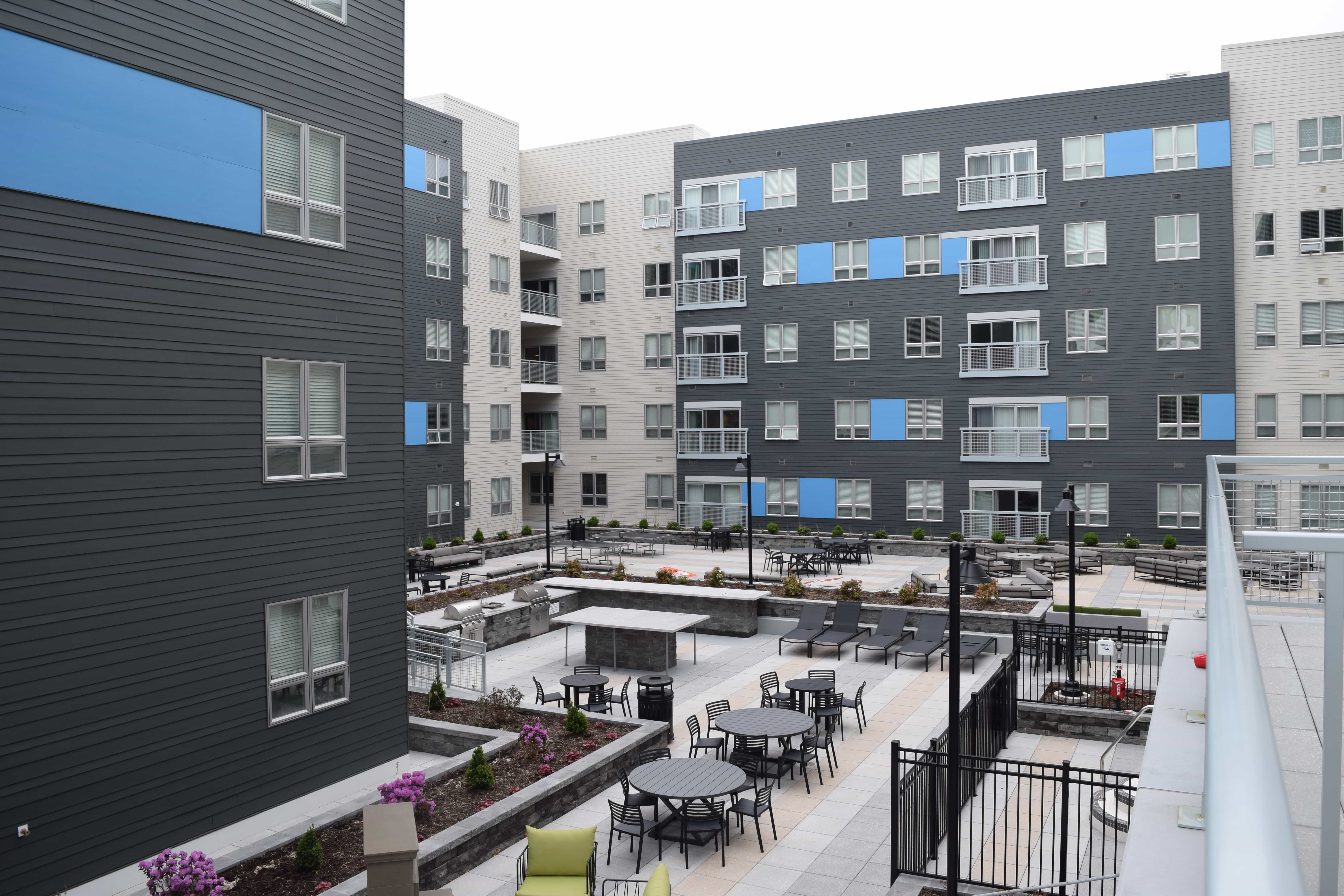 The courtyard at Theory, with tables, chairs and grills.