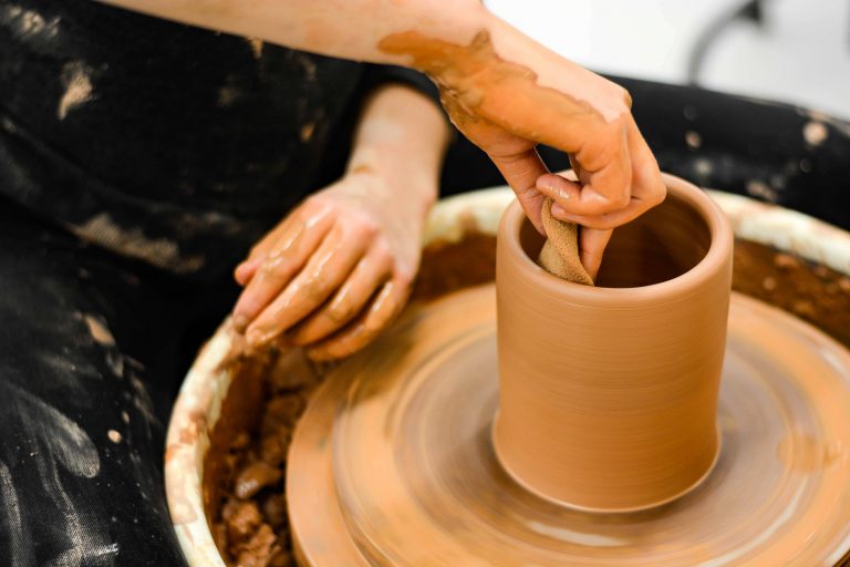 Ceramicist Isabel Souza throws a pot in the ComArts Studio on South Campus.