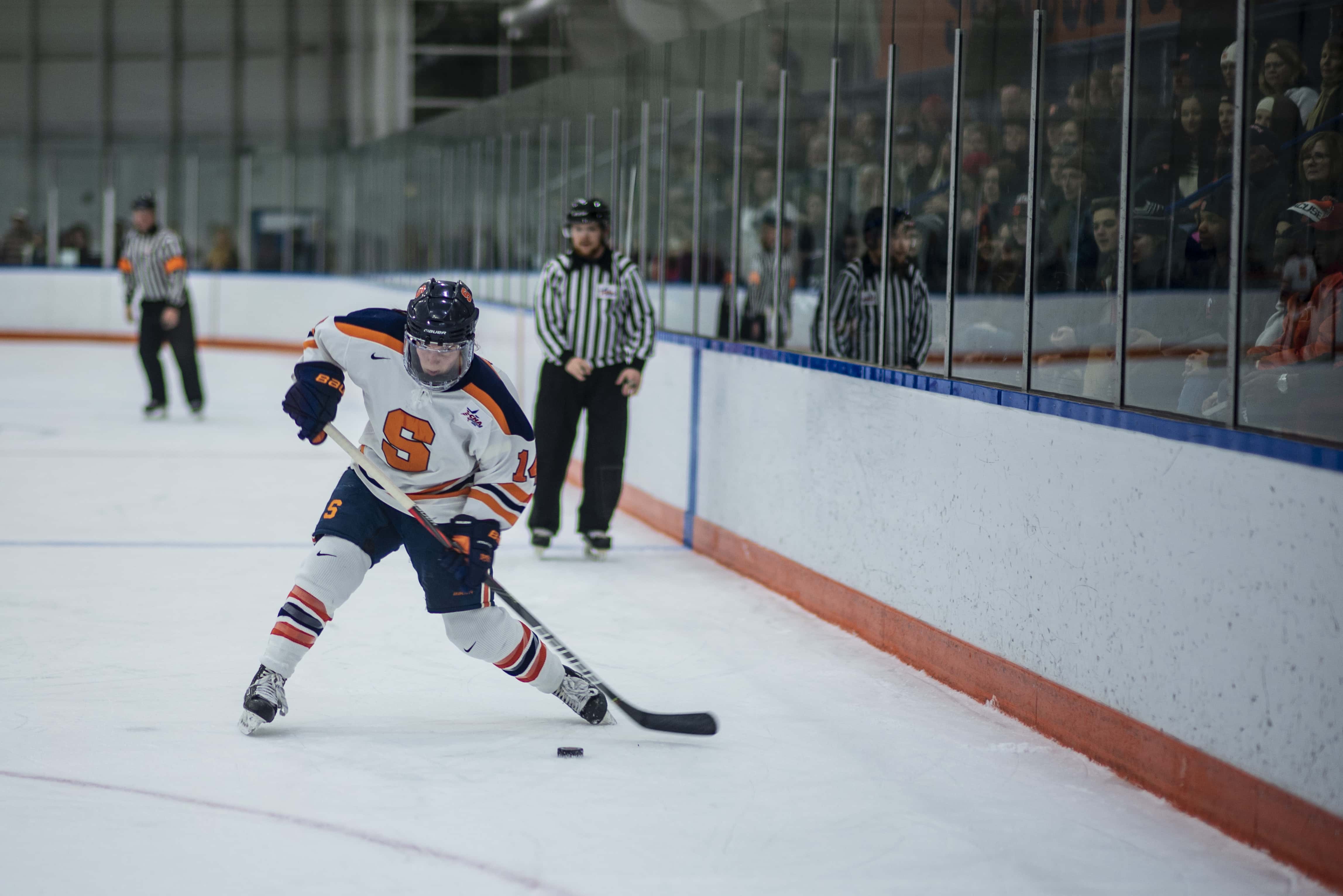 Savannah Rennie, senior at Syracuse University, shoots the hockey puck during the Syracuse Women's Ice Hockey home game against Pennsylvania state, at the Tennity Ice Pavilion in Syracuse, New York.