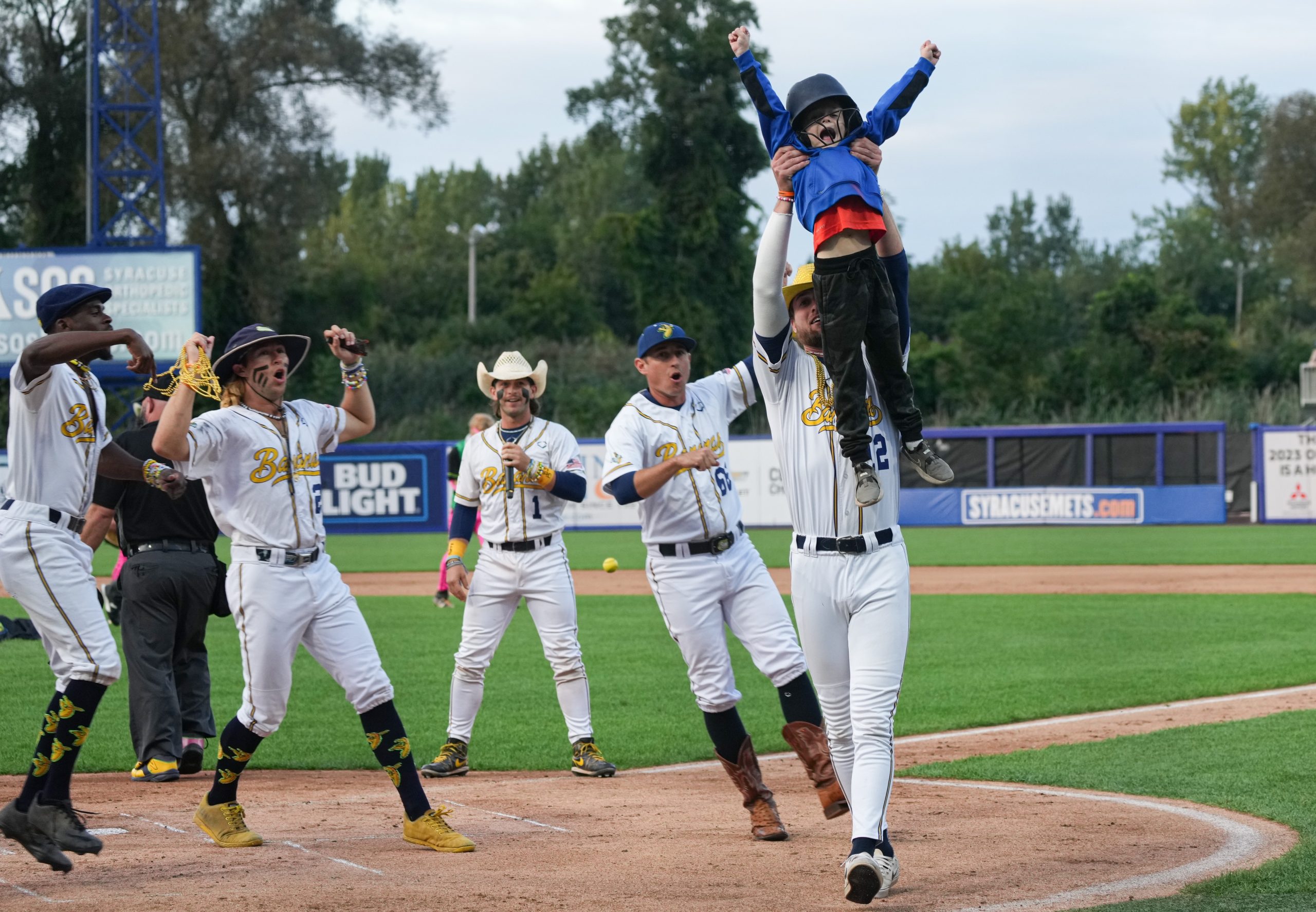 A child is held up after he ran the beasts for a home run after the hit a ball on a tee at the Savannah Banana’s baseball game held Thursday night, September 14, 2023 at NBT Stadium in Syracuse, NY.