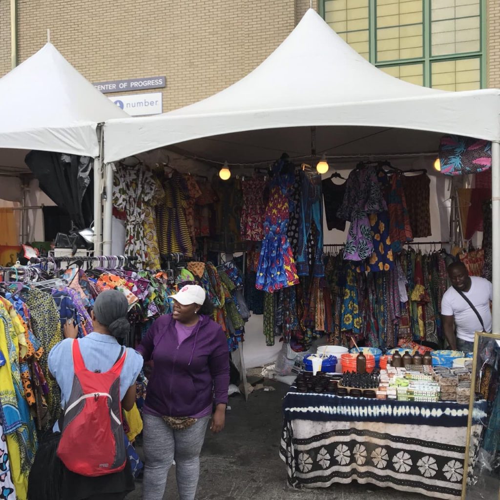 A vendor selling clothing and other items in the Pan African village at the 2019 New York State Fair.