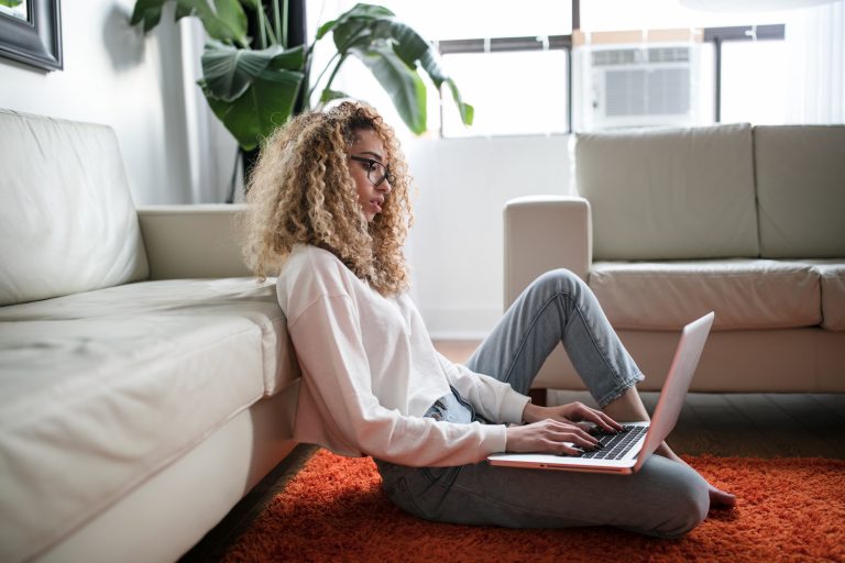 Woman searching laptop in living area