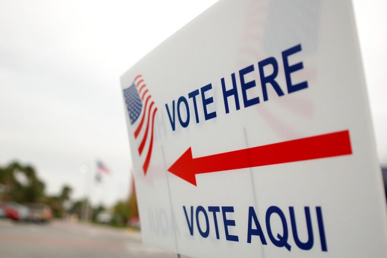 "Vote here" sign points voters to polling stations