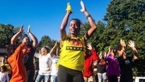 A yellow shirt-clad instructor from Wacheva's Dancing and Drumming Group leads participants through a Zumba dance on the Harvard Dance Stage at the 27th annual Westcott Street Cultural Fair. Wacheva is an organization that "presents and supports multicultural dance, drum, and fitness programming in the Central New York community," according to their website.