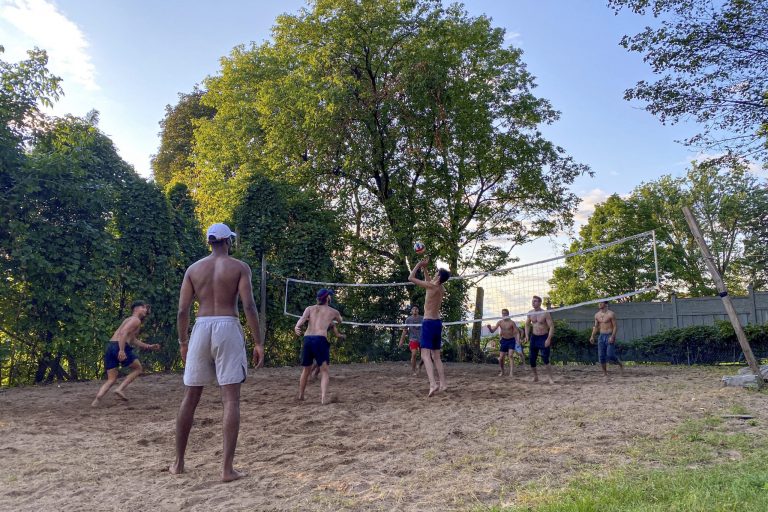 Senior Harrison Stier sets the ball to his teammate in a game of beach volleyball outside the Delta Kappa Epsilon fraternity house. "We only get this weather for a short amount of time, so we have to make the most of it," Stier said.