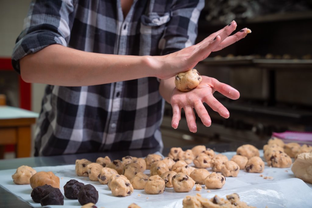 Via Carpenter rolls cookie dough for her business Via's Cookies