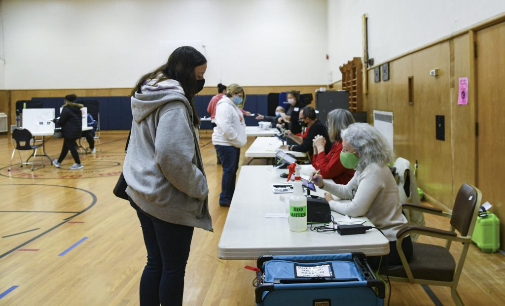 A voter checks in at the Salina Town Hall polling station before casting their ballot.