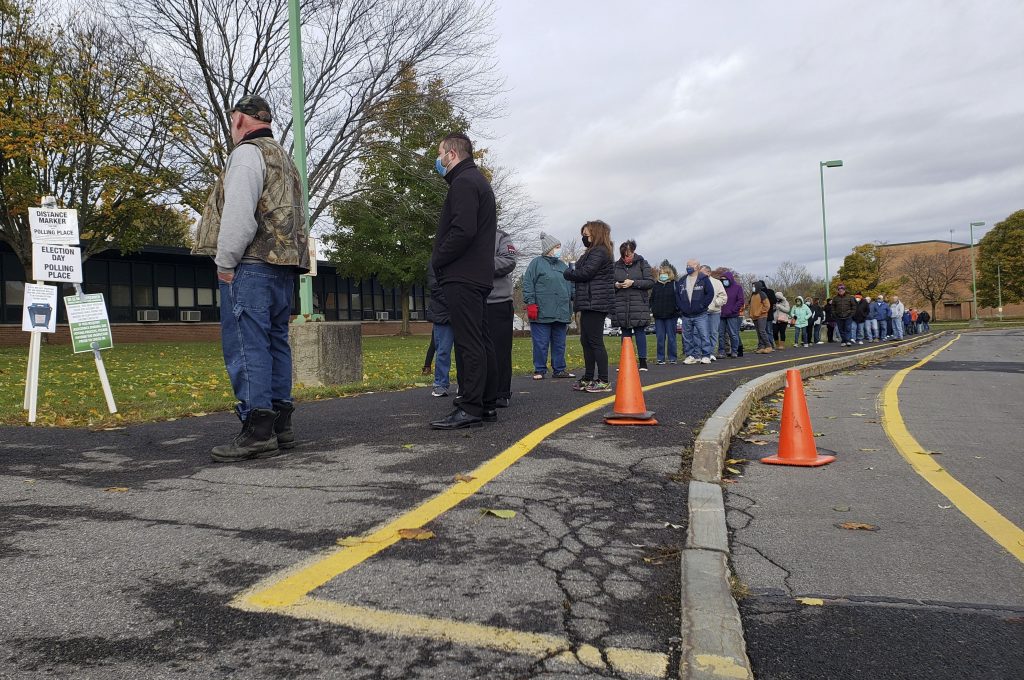 Wait times lasted about 45 minutes at the Northern Syracuse School Office this morning as voters waited patently budled and masked up.