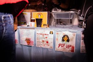 Placards display the menu for Mariah B’s CBD pop-up food table at a party.