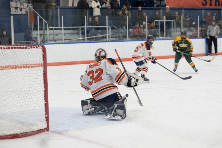 SU goalie, Arielle DeSmet, a graduate student from Charlotte, VT blocks a shot from UVM during the women's Ice Hockey game on Friday, December 9, 2022 at Tennity Ice Pavilion in Syracuse, NY.