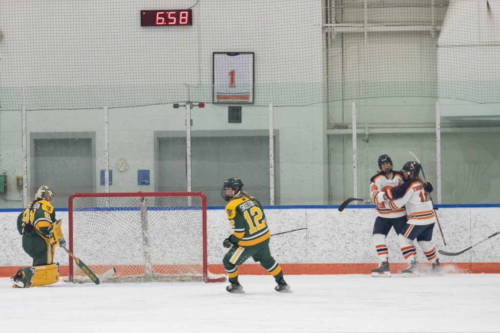Tatum White (#18), a junior from Kingston, Ontario celbrates with Sarah Thompson (#11) after she scores on UV for the only score in the 2nd period during the women's Ice Hockey game on Friday, December 9, 2022 at Tennity Ice Pavilion in Syracuse, NY.