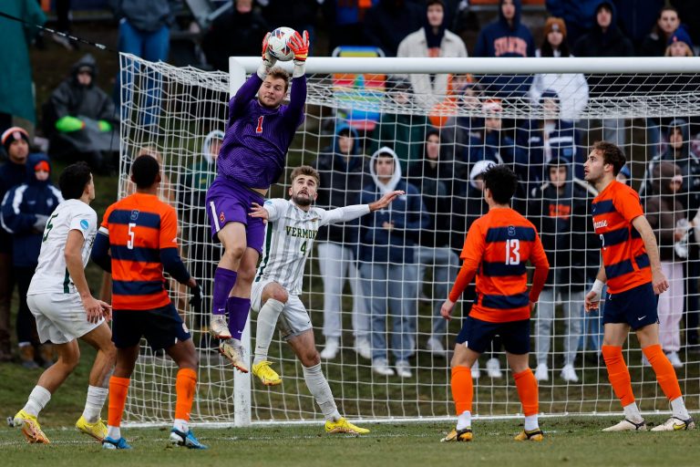 SYRACUSE, NY - DECEMBER 3: Russell Shealy #1 of the Syracuse Orange reaches for a save over Garrett Lillie #4 of the Vermont Catamounts during the quarterfinals of the NCAA Men’s Soccer Championship at SU Soccer Stadium on December 3, 2022 in Syracuse, New York. (Photo by Isaiah Vazquez/The Newhouse)