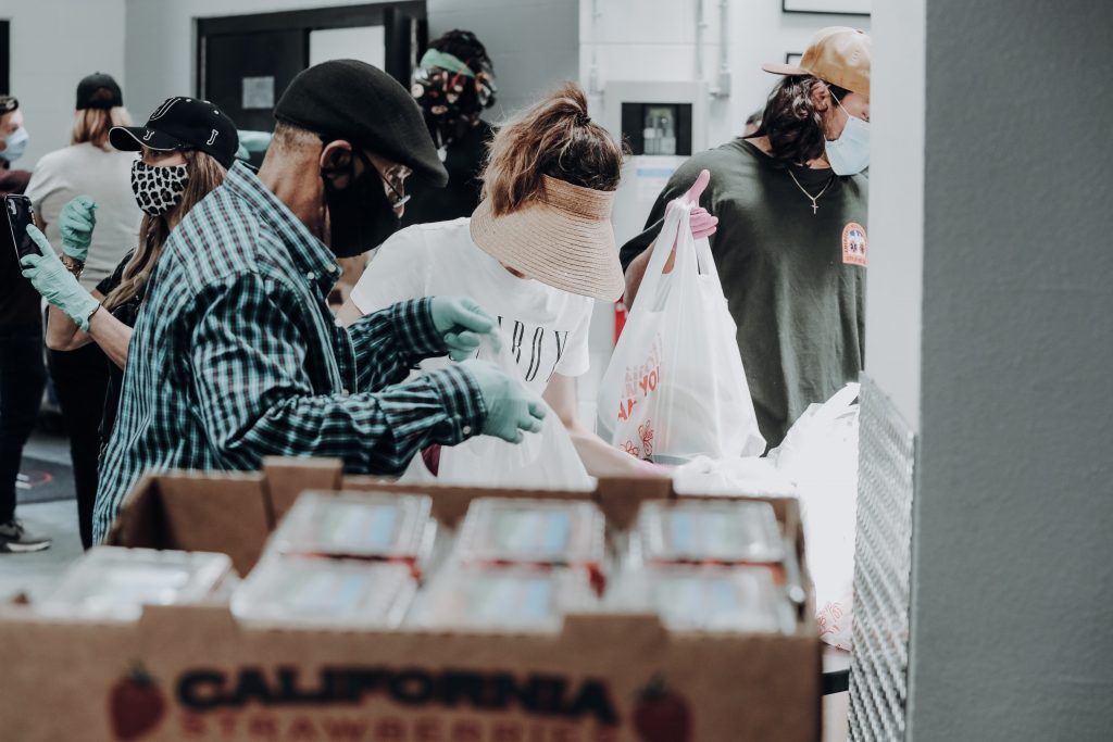 Volunteers help sort bags of food