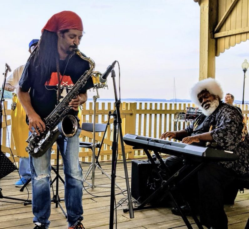 Julian Meyers performs on the tenor saxophone at an outdoor gig at the Perth Amboy Historical Ferry Slip in New Jersey.
