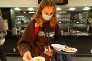 An SU students takes samples of vegan food at Sadler dining hall