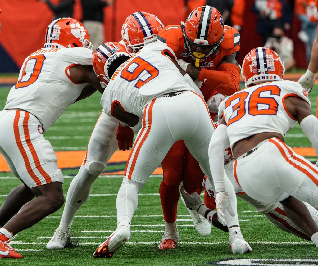 Syracuse’s LeQuint Allen tries to make his way through a host of Clemson defensemen at the football game against Clemson in Syracuse, N.Y., Saturday, Sept. 30, 2023.